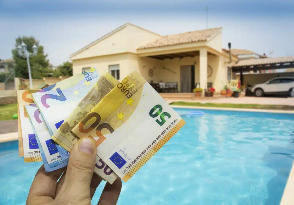Backyard pool with someone holding money