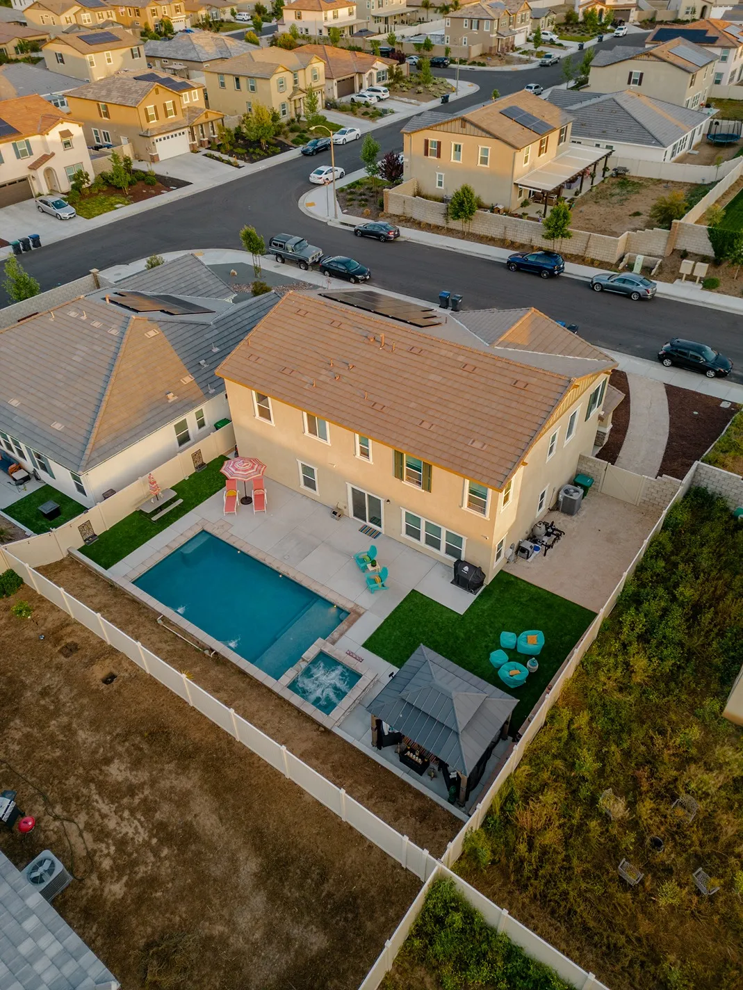 Pool Builder Serving Southern California and Southern Utah 9 Modern residential backyard pool with patio and outdoor seating, showcasing quality pool construction for homeowners researching pool builders in Corona, CA.