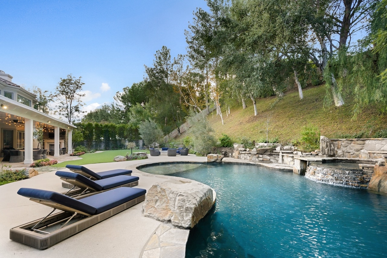 backyard pool next to hill