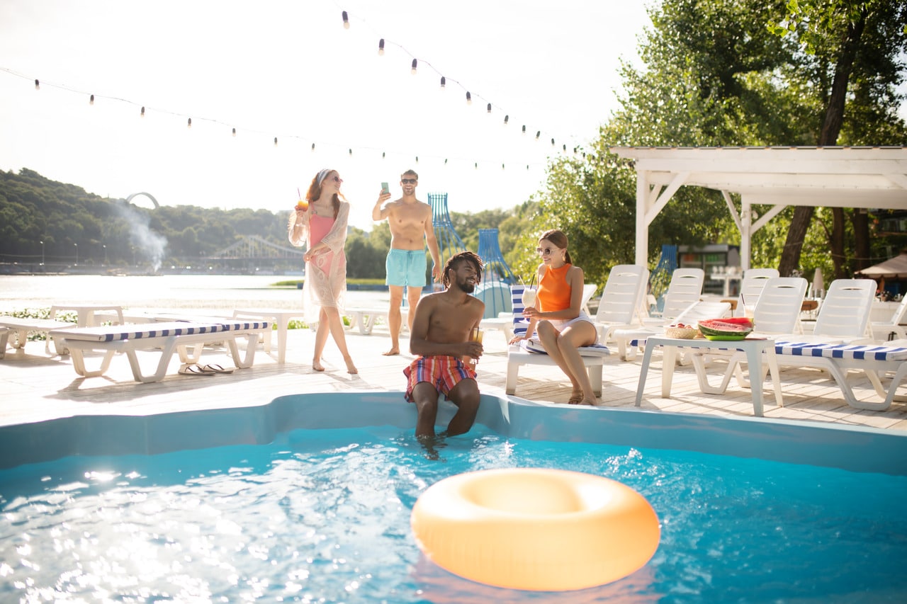 Two couples having a pool party