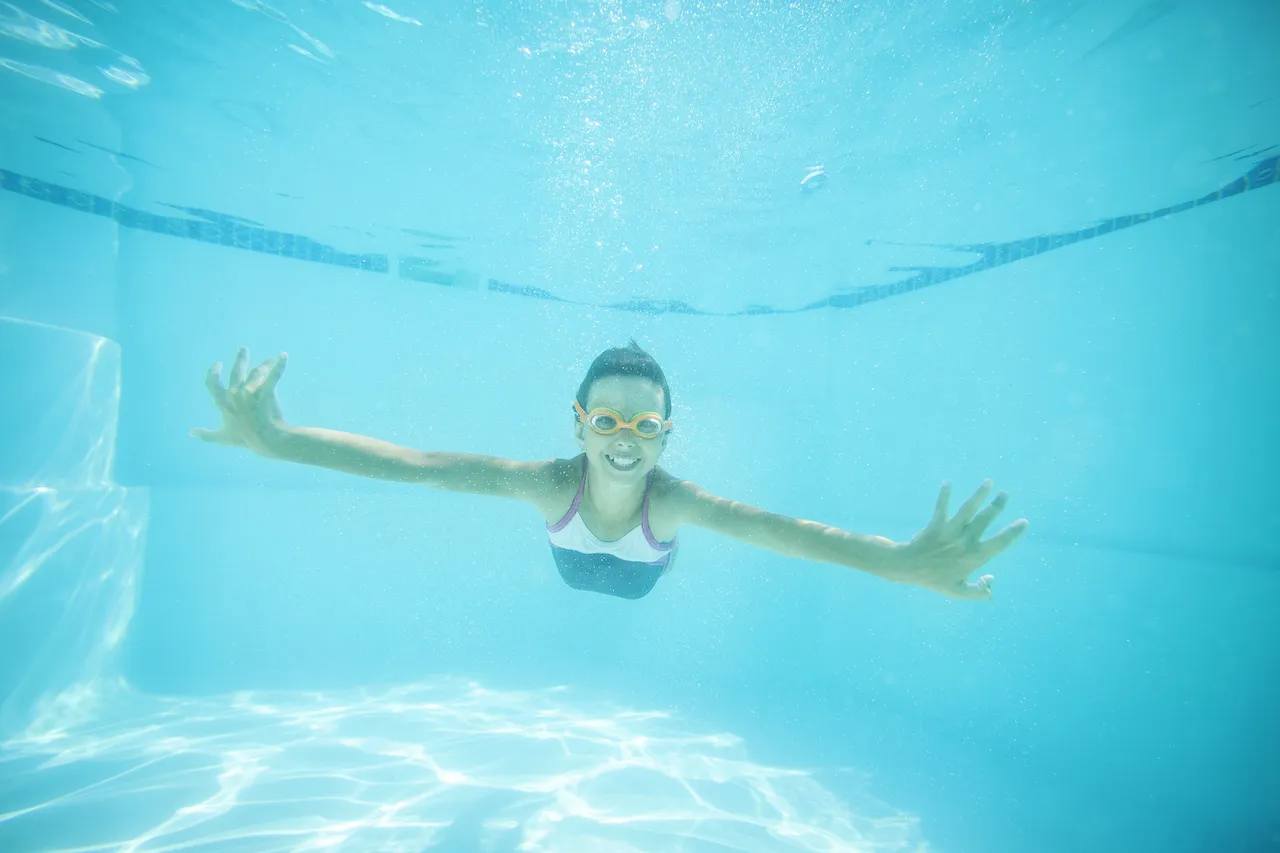 Blog 3 joyful girl swimming underwater in residential pool