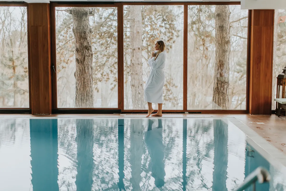 Blog 1 Women walking by a pool that's next to a window