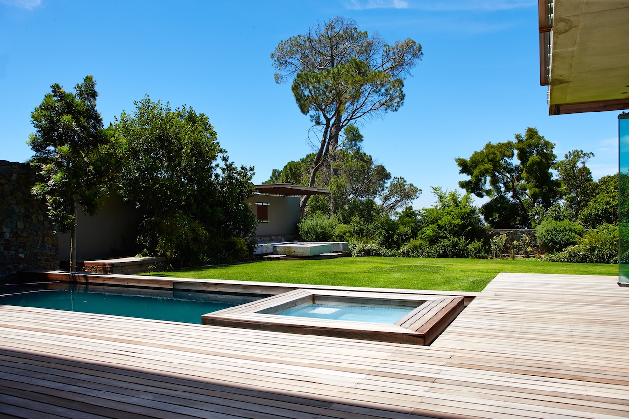 modern backyard with a pool and raised spa