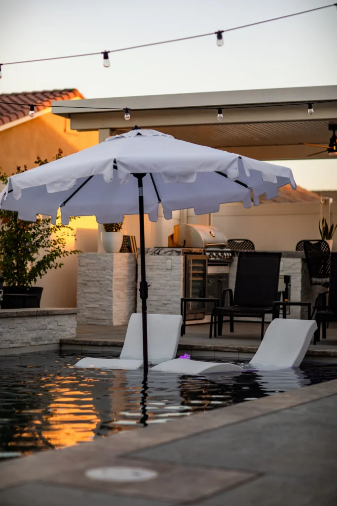 Outdoor oasis design featuring a stylish backyard with seating, greenery, and ambient lighting