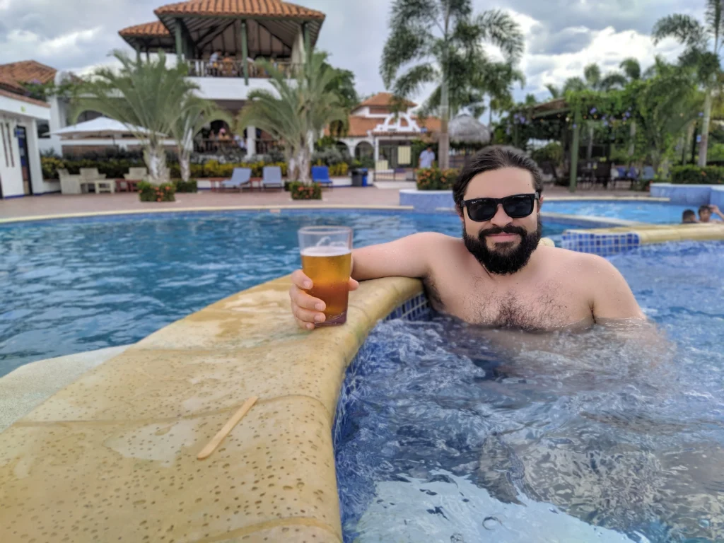 Person relaxing in a resort-style swimming pool in St. George, Utah on a warm sunny day